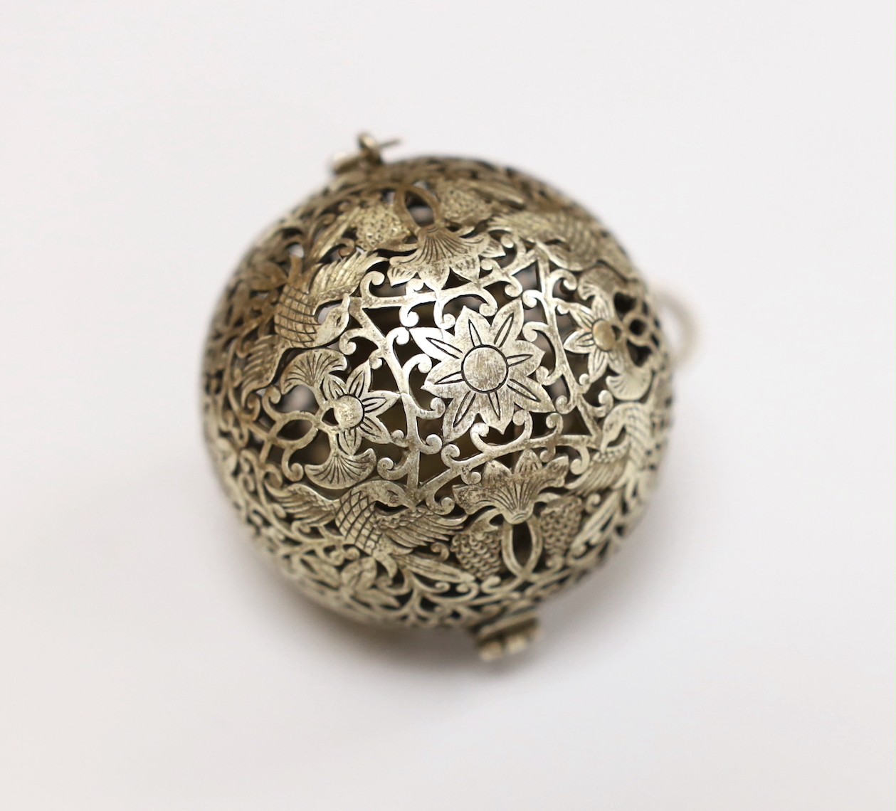 A Chinese spherical ornately worked metal perfume holder, 5.2cm